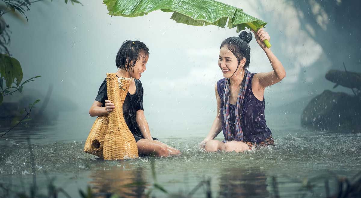 due ragazze che si divertono sotto la pioggia